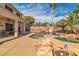 Backyard pool with rock features, water slide, and covered patio perfect for outdoor entertaining at 790 Tossa De Mar Ave, Henderson, NV 89002