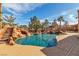 Backyard pool with waterfall, waterslide, spa, and tropical landscaping that provides a relaxing oasis at 790 Tossa De Mar Ave, Henderson, NV 89002