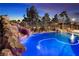 Beautiful backyard pool with rock waterfall feature providing a relaxing outdoor oasis at 790 Tossa De Mar Ave, Henderson, NV 89002