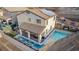 Aerial view of a home showcasing a large pool, covered patio, and solar panels at 864 Firestone Ledge Ave, Henderson, NV 89012