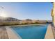 An alluring narrow backyard pool offers a peaceful retreat with mountain views and serene privacy at 864 Firestone Ledge Ave, Henderson, NV 89012