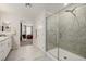 Bathroom featuring a large, glass-enclosed shower, tile flooring, and granite countertops at 864 Firestone Ledge Ave, Henderson, NV 89012