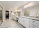 Spacious bathroom featuring dual sinks, granite counters, and a walk-in closet at 864 Firestone Ledge Ave, Henderson, NV 89012