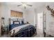 Cozy bedroom features a decorative metal bed frame, ceiling fan, and complementing wall art at 864 Firestone Ledge Ave, Henderson, NV 89012