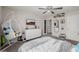 Bright bedroom with a ceiling fan, a comfy hanging chair, and a TV with a southwestern landscape image at 864 Firestone Ledge Ave, Henderson, NV 89012