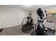 Carpeted exercise room featuring a treadmill, exercise bike, and doorway at 864 Firestone Ledge Ave, Henderson, NV 89012