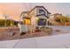 Beautifully landscaped front yard of a two-story home with a three-car garage and stone accents at 864 Firestone Ledge Ave, Henderson, NV 89012