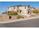 Inviting two-story home with a manicured lawn, complemented by mature landscaping and attractive architectural details at 864 Firestone Ledge Ave, Henderson, NV 89012