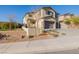 Two story home showcasing a two-car garage, complemented by drought-resistant landscaping and manicured lawn at 864 Firestone Ledge Ave, Henderson, NV 89012