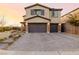 Charming two-story home featuring a three-car garage and attractive brick driveway at 864 Firestone Ledge Ave, Henderson, NV 89012