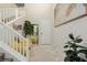 Inviting foyer features a staircase, art, a mirror, a decorative rug, and a plant at 864 Firestone Ledge Ave, Henderson, NV 89012