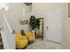 Bright foyer with a staircase, modern decor, and stylish yellow chairs creating a welcoming entrance at 864 Firestone Ledge Ave, Henderson, NV 89012