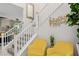 Foyer featuring a staircase, modern decor, and stylish yellow chairs creating a welcoming entrance at 864 Firestone Ledge Ave, Henderson, NV 89012