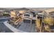 Aerial view of the home's front exterior with a wide driveway and desert landscaping at 864 Firestone Ledge Ave, Henderson, NV 89012