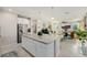 Spacious kitchen island with white cabinets and granite countertop adjacent to the living area at 864 Firestone Ledge Ave, Henderson, NV 89012