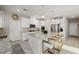 A modern kitchen featuring white cabinets, a large center island with seating, and stainless steel appliances at 864 Firestone Ledge Ave, Henderson, NV 89012