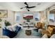 Bright living room with modern decor, natural light, and a ceiling fan at 864 Firestone Ledge Ave, Henderson, NV 89012