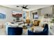 Cozy living room featuring blue and gold seating, modern decor, and a mounted TV at 864 Firestone Ledge Ave, Henderson, NV 89012