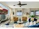 Cozy living room with a large window, ceiling fan, and comfortable seating at 864 Firestone Ledge Ave, Henderson, NV 89012