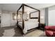 Primary bedroom featuring a canopy bed, accent chairs, and en-suite bathroom at 864 Firestone Ledge Ave, Henderson, NV 89012