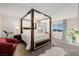 Spacious bedroom featuring a four-poster bed, chandelier, accent chair, and natural light at 864 Firestone Ledge Ave, Henderson, NV 89012