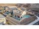 Aerial view of home's back exterior featuring a sparkling pool, covered patio, and solar panels on the roof at 864 Firestone Ledge Ave, Henderson, NV 89012