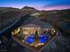 Aerial view of a fenced backyard with a pool, lounge chairs, and views of distant mountains at 91 Alta Cascata Pl, Henderson, NV 89011