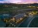 Stunning aerial view of a home overlooking a golf course, pond, and the city skyline at 91 Alta Cascata Pl, Henderson, NV 89011