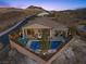 Aerial view of a fenced backyard with a pool, lounge chairs, and a view of mountains at 91 Alta Cascata Pl, Henderson, NV 89011