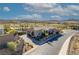 Aerial view of a single-story home with a charming brick driveway surrounded by mature landscaping and lush green golf course views at 91 Alta Cascata Pl, Henderson, NV 89011