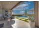 Inviting back porch with comfortable seating overlooking a pool with water feature and mountain views at 91 Alta Cascata Pl, Henderson, NV 89011