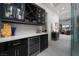 Modern bar area with wine storage, marble countertops, and dark cabinetry at 91 Alta Cascata Pl, Henderson, NV 89011