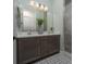 Bathroom featuring a double sink vanity, decorative tile flooring, quartz counters, and a tiled shower enclosure at 91 Alta Cascata Pl, Henderson, NV 89011