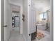 Hallway view into a luxurious bathroom featuring a soaking tub, glass shower and elegant fixtures at 91 Alta Cascata Pl, Henderson, NV 89011