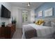 Cozy bedroom featuring stylish decor, dresser, and ample natural light at 91 Alta Cascata Pl, Henderson, NV 89011