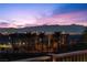 Distant city view with palm trees in the foreground silhouetted against the night sky at 91 Alta Cascata Pl, Henderson, NV 89011