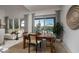 Dining area with a modern table set, pool view, stylish decor, and bright, natural light at 91 Alta Cascata Pl, Henderson, NV 89011