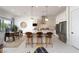 Bright, open kitchen featuring granite countertops, stainless appliances, and a central island with bar stool seating at 91 Alta Cascata Pl, Henderson, NV 89011