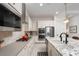 Kitchen with island seating, modern lighting, stainless steel appliances, and sleek backsplash at 91 Alta Cascata Pl, Henderson, NV 89011