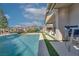 Inviting pool area with a serene water feature and relaxing lounge seating under a striped umbrella at 91 Alta Cascata Pl, Henderson, NV 89011