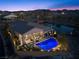 Aerial view of backyard with pool, patio, and mountain views at dusk at 91 Alta Cascata Pl, Henderson, NV 89011