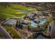 Aerial view of the community sports club featuring pools, tennis courts, and lush green spaces at 91 Alta Cascata Pl, Henderson, NV 89011