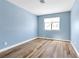 Light blue bedroom with wood-look floors and window coverings at 9101 Dolphin Cove Ct, Las Vegas, NV 89117