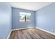 Light blue bedroom with wood-look floors and window coverings at 9101 Dolphin Cove Ct, Las Vegas, NV 89117