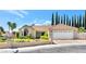 Single-story home with a two-car garage and landscaped front yard at 9101 Dolphin Cove Ct, Las Vegas, NV 89117