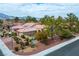 A elevated view of a single-story home with well-maintained landscaping, a tile roof and brick driveway at 9300 Villa Ridge Dr, Las Vegas, NV 89134