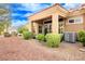 A cozy backyard featuring a covered patio, trimmed shrubbery and desert landscaping at 9300 Villa Ridge Dr, Las Vegas, NV 89134