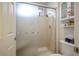 Bathroom featuring a stall shower with glass door, toilet, and storage shelves and cabinet at 9300 Villa Ridge Dr, Las Vegas, NV 89134