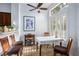 Bright breakfast nook features a ceiling fan, a square table with seating, and plantation shutters on the windows at 9300 Villa Ridge Dr, Las Vegas, NV 89134