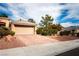 Charming home featuring a tile roof, well-manicured landscaping and a brick driveway leading to the garage at 9300 Villa Ridge Dr, Las Vegas, NV 89134